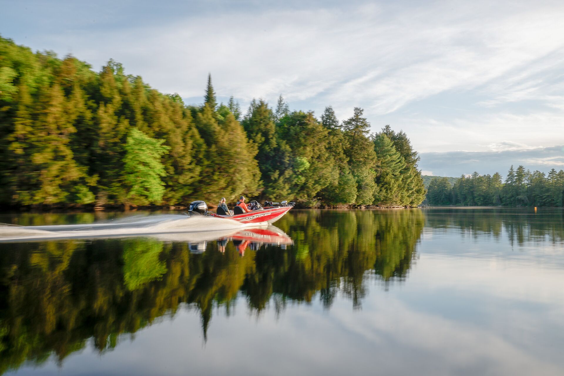 Red bass boat moves fast on lake, enjoy the best boating lakes in the US concept. 