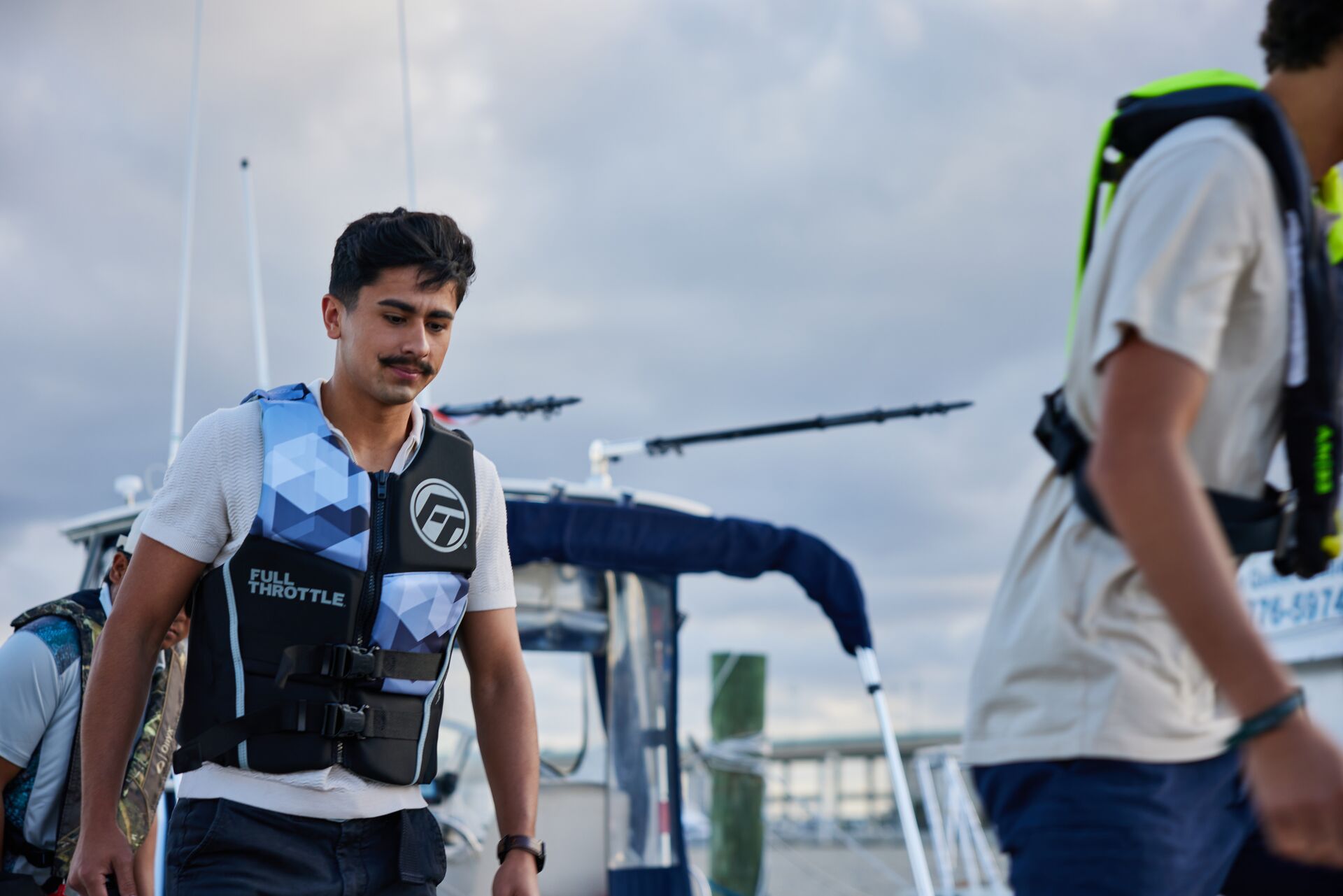 Two guys walking in life jackets, know life jacket laws by state.