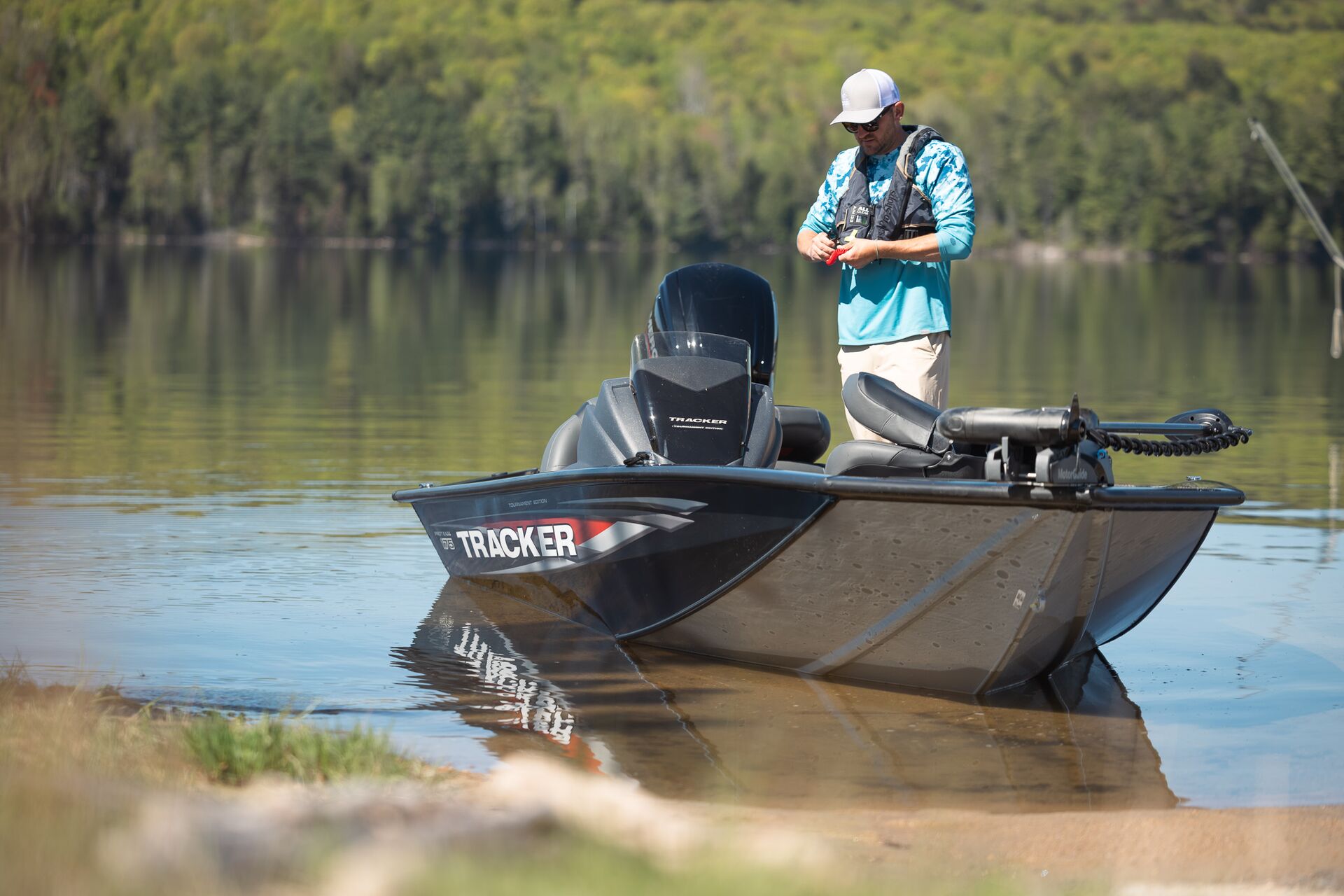 Angler on a fishing boat near shore, best boating lakes in Colorado concept. 