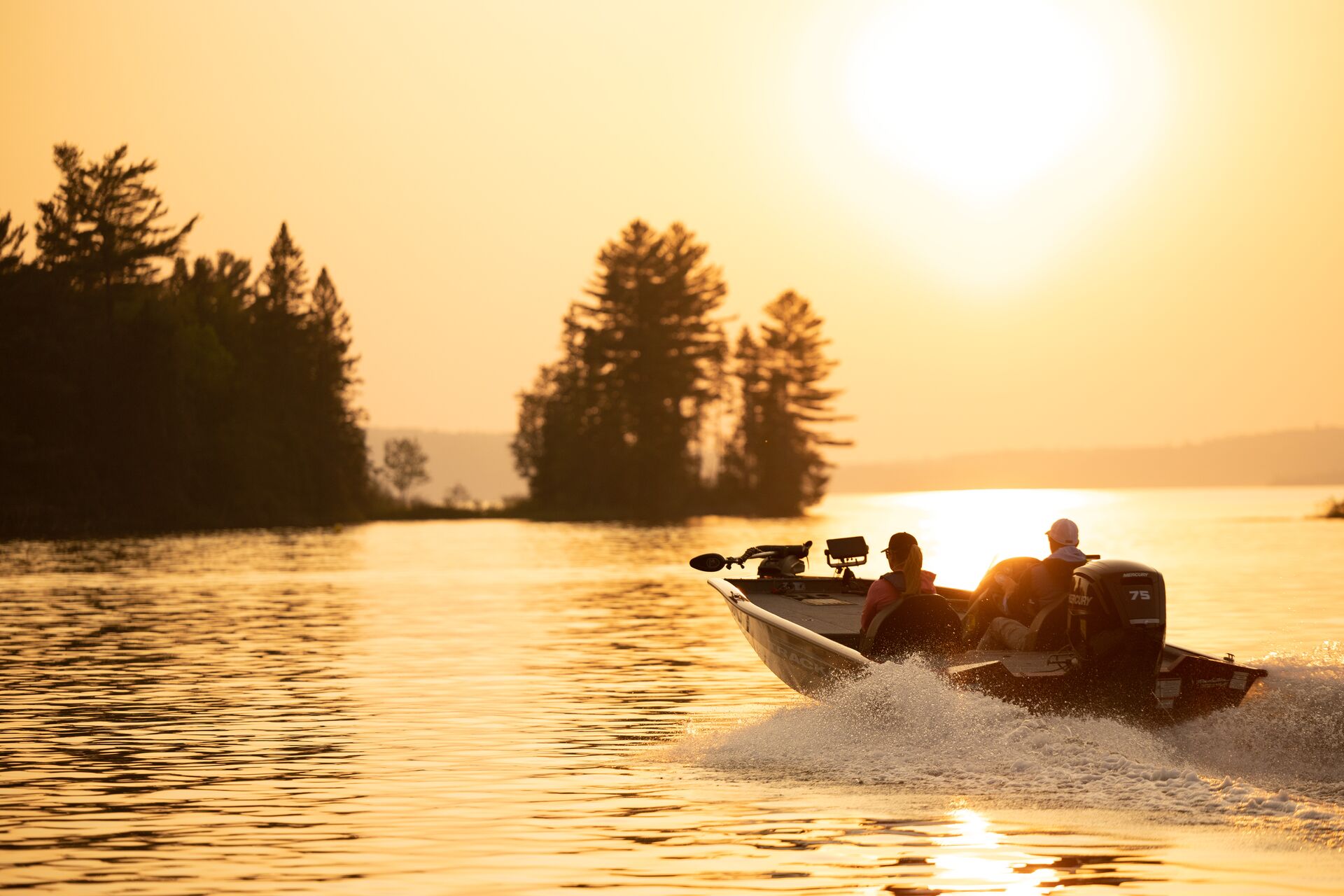Two people in fishing boat on lake at sunset, take the Nevada boating exam concept. 