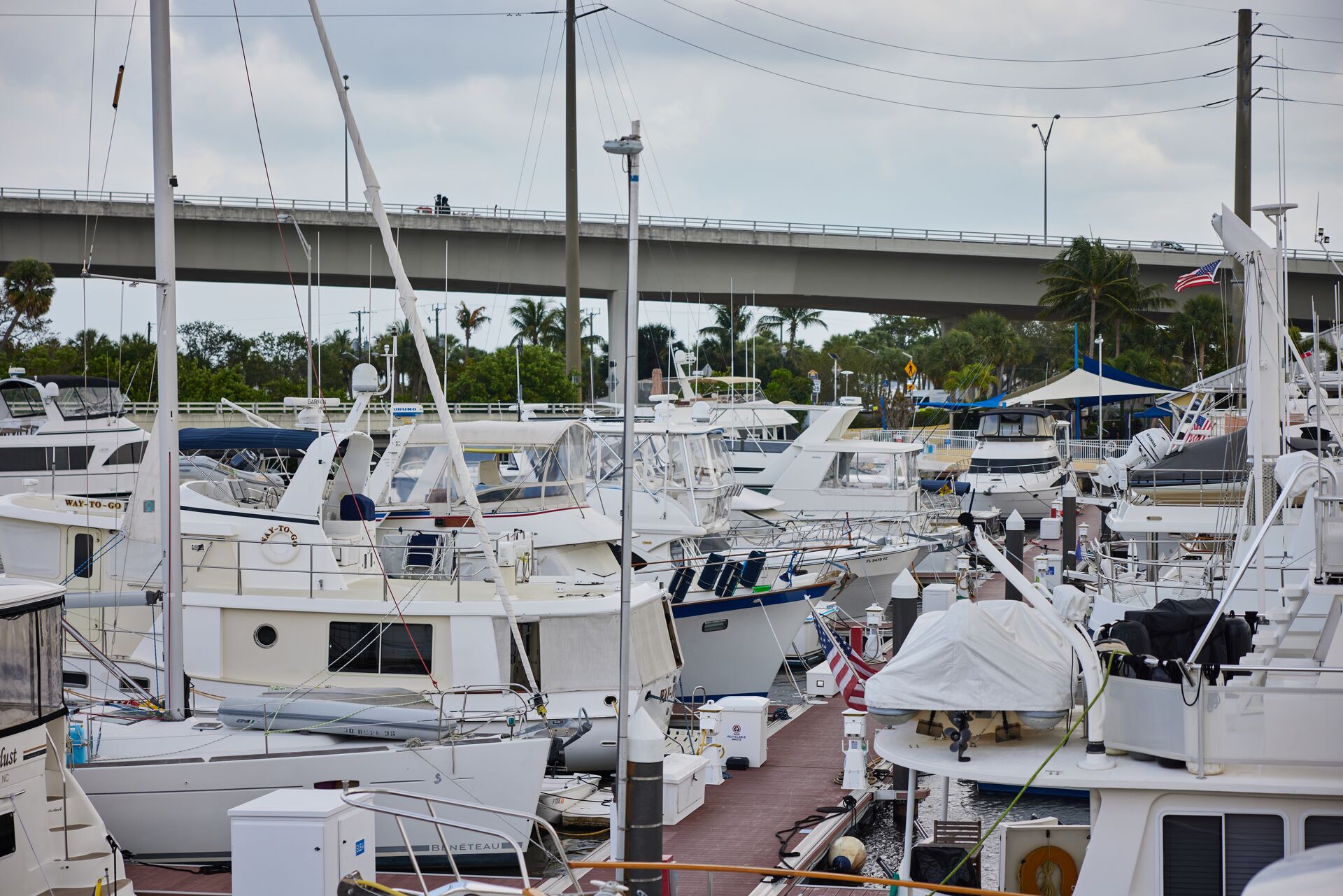 Many boats docked at a marina, boat hull types concept.