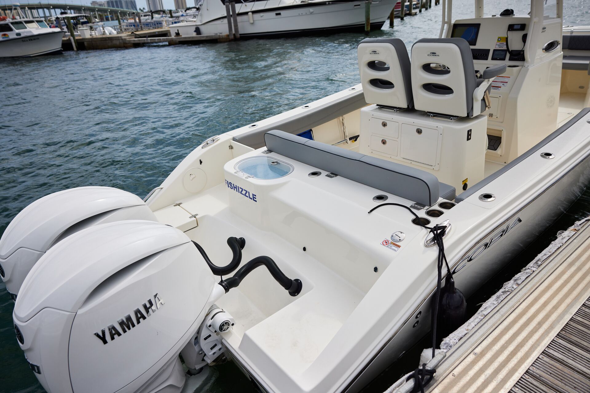 A boat at the dock with an outboard motor. 