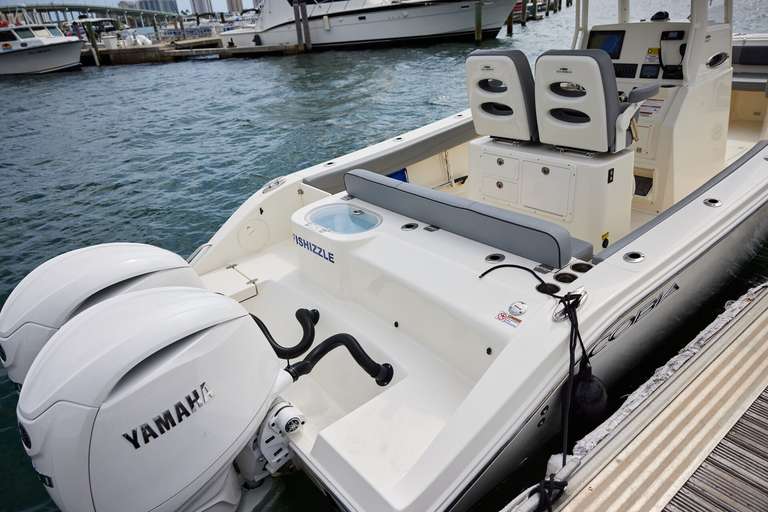 A boat at the dock with an outboard motor. 