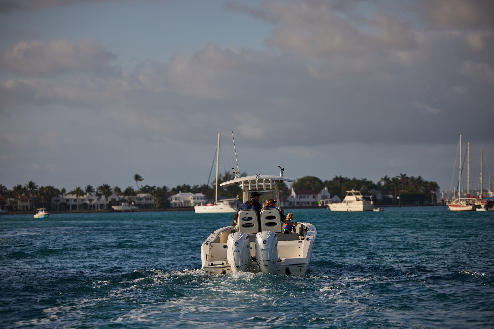 A boat on the water with a dark cloud on the horizon.