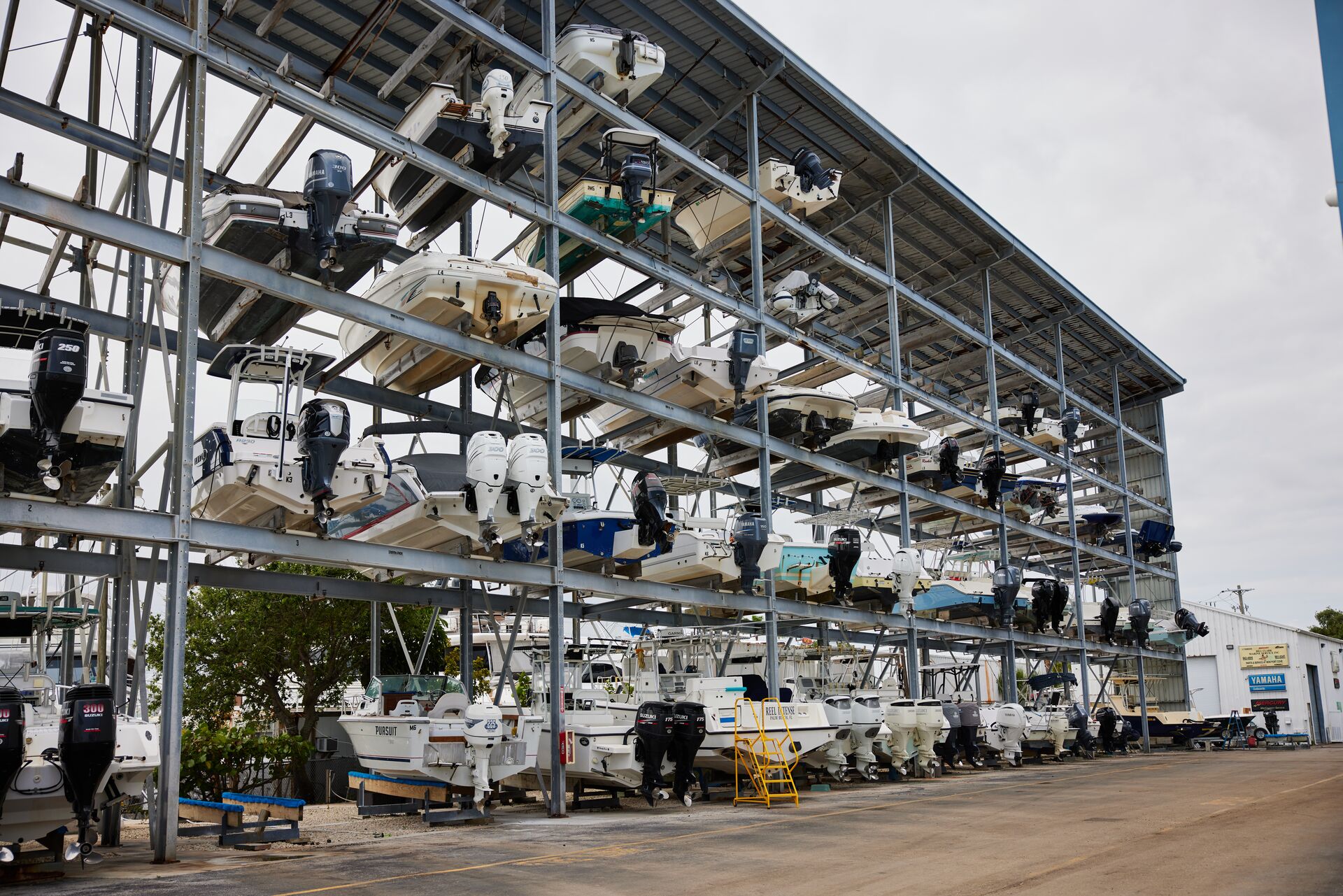 Many boats stored on racks at a marina, boat maintenance tips concept.