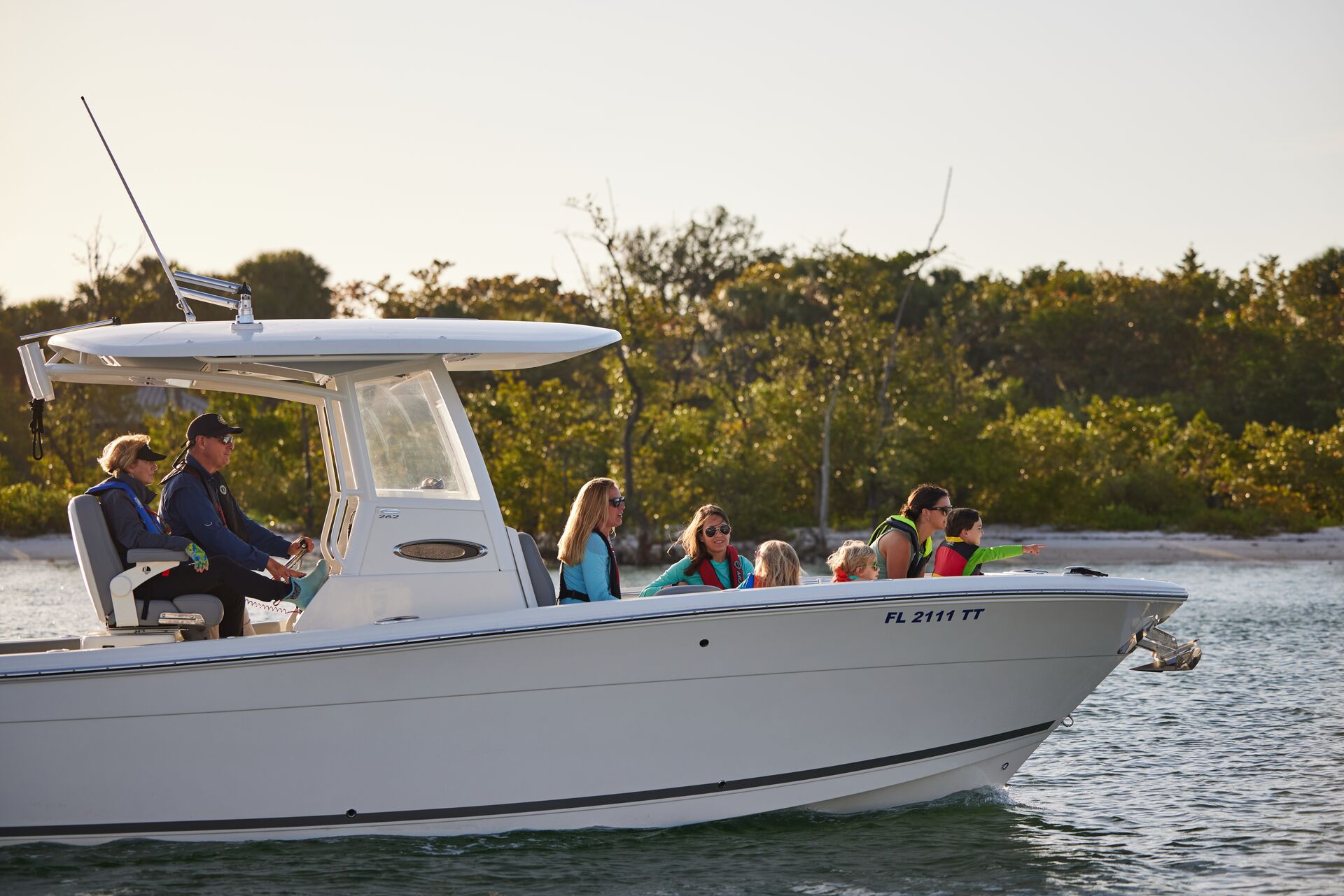 People wearing life jackets while enjoying a boat on the water.