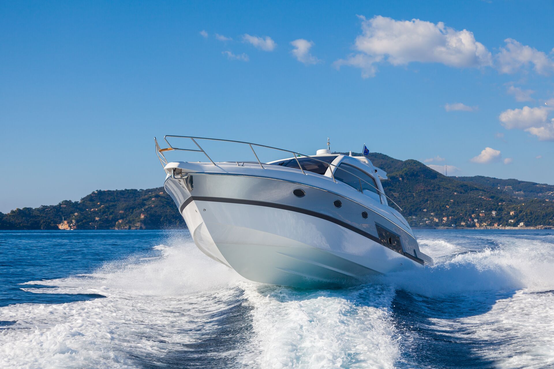 A boat moving quickly toward the camera creating a wake.