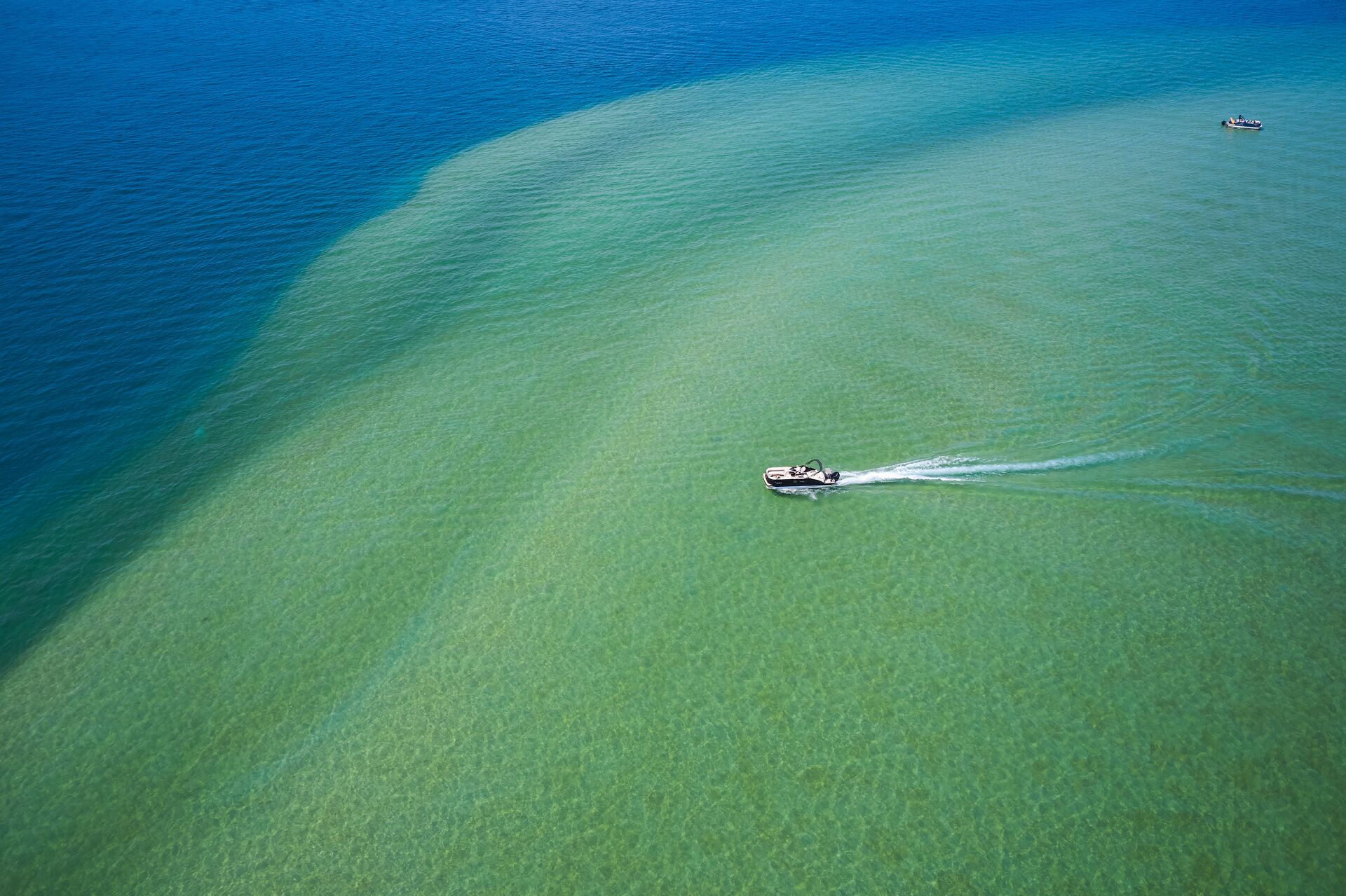 Overhead view of a boat on a sandbar, avoid running aground concept. 