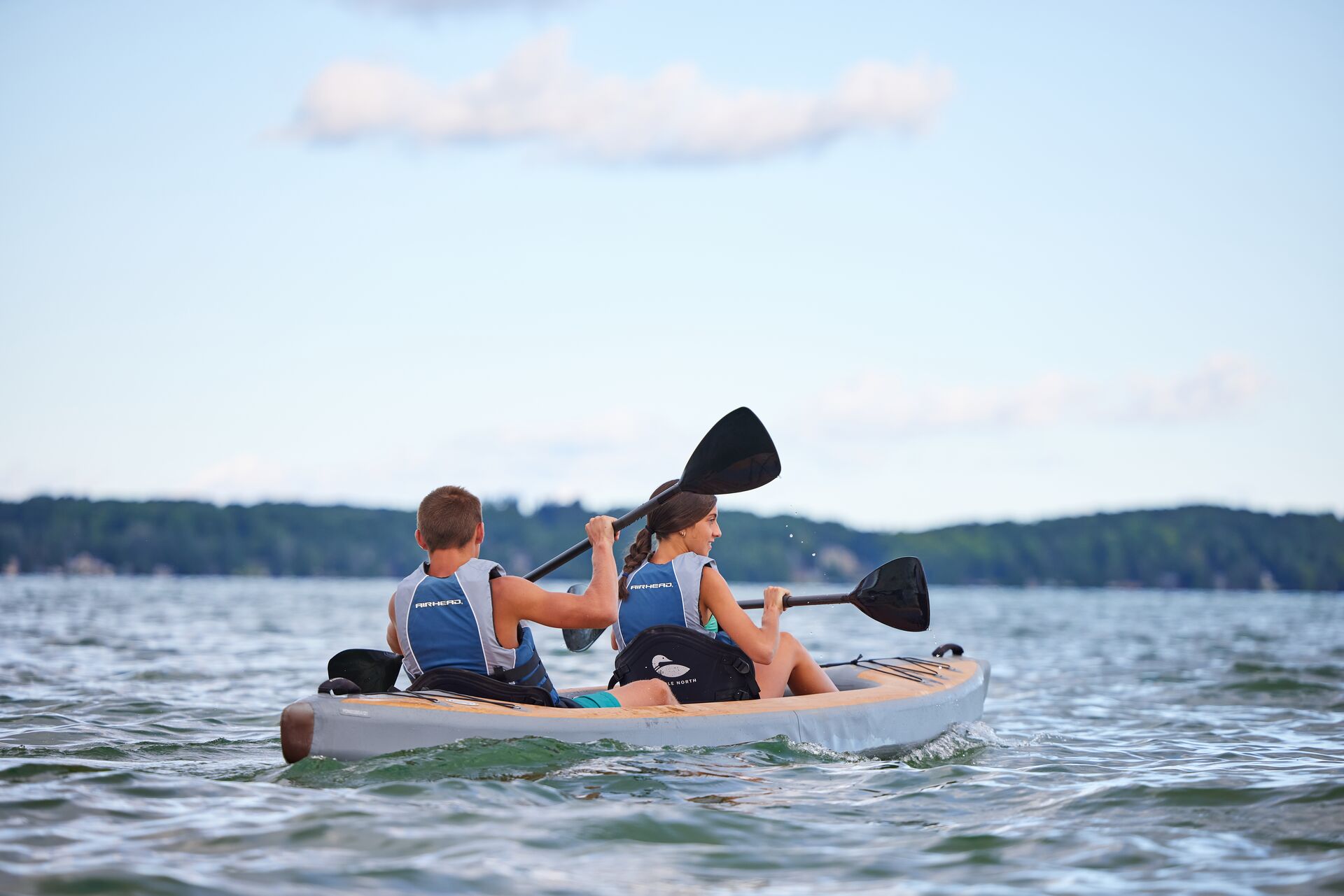 Two people paddling a kayak away.