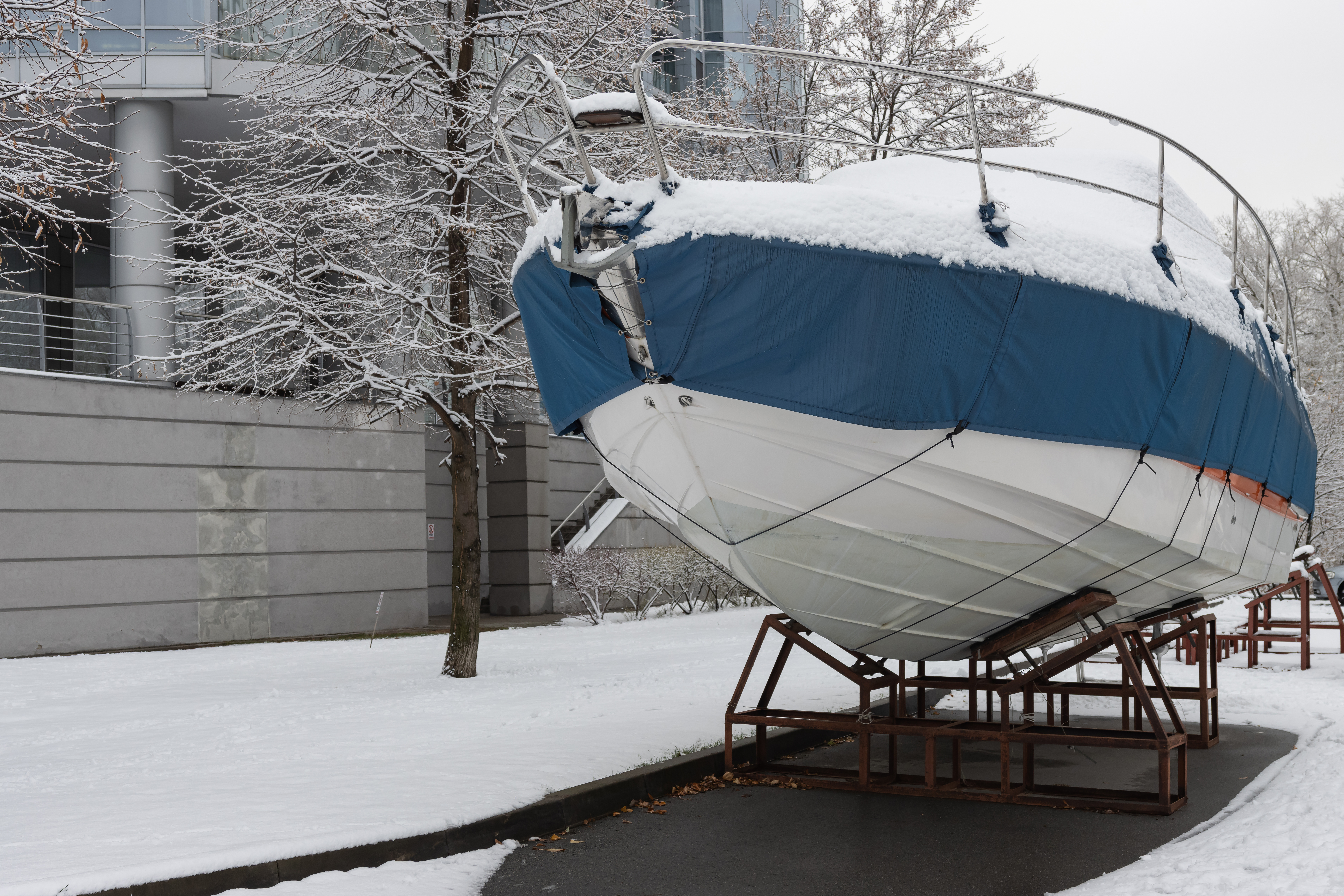 A boat covered in snow, winterizing a boat this season concept. 