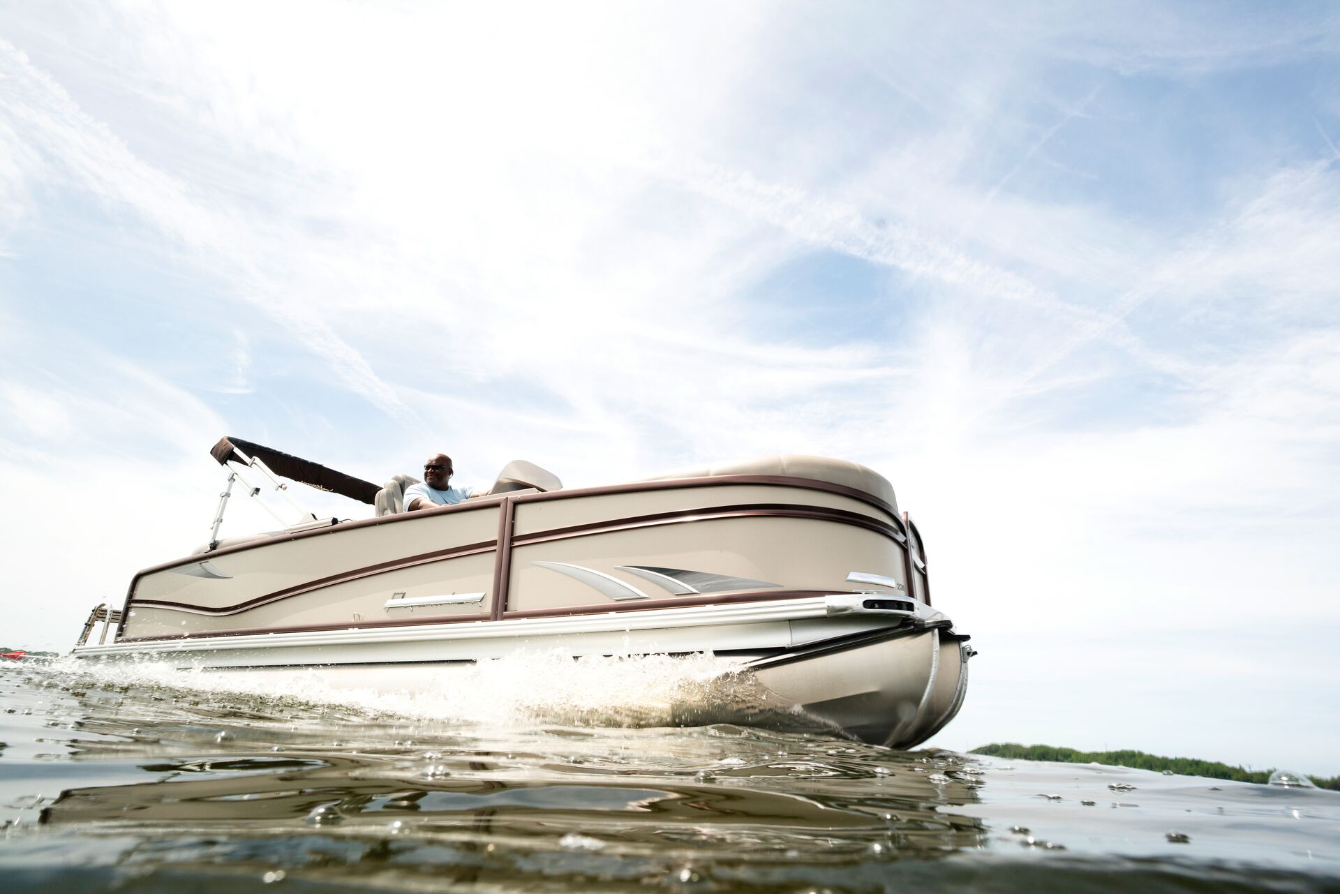 Side view of a pontoon boat on the water.
