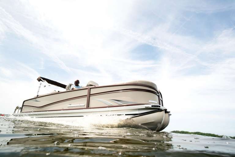 Side view of a pontoon boat on the water.