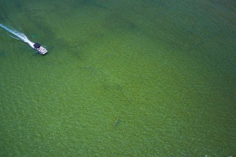 Aerial view of a boat in shallow water, what to do when boating in shallow areas concept. 