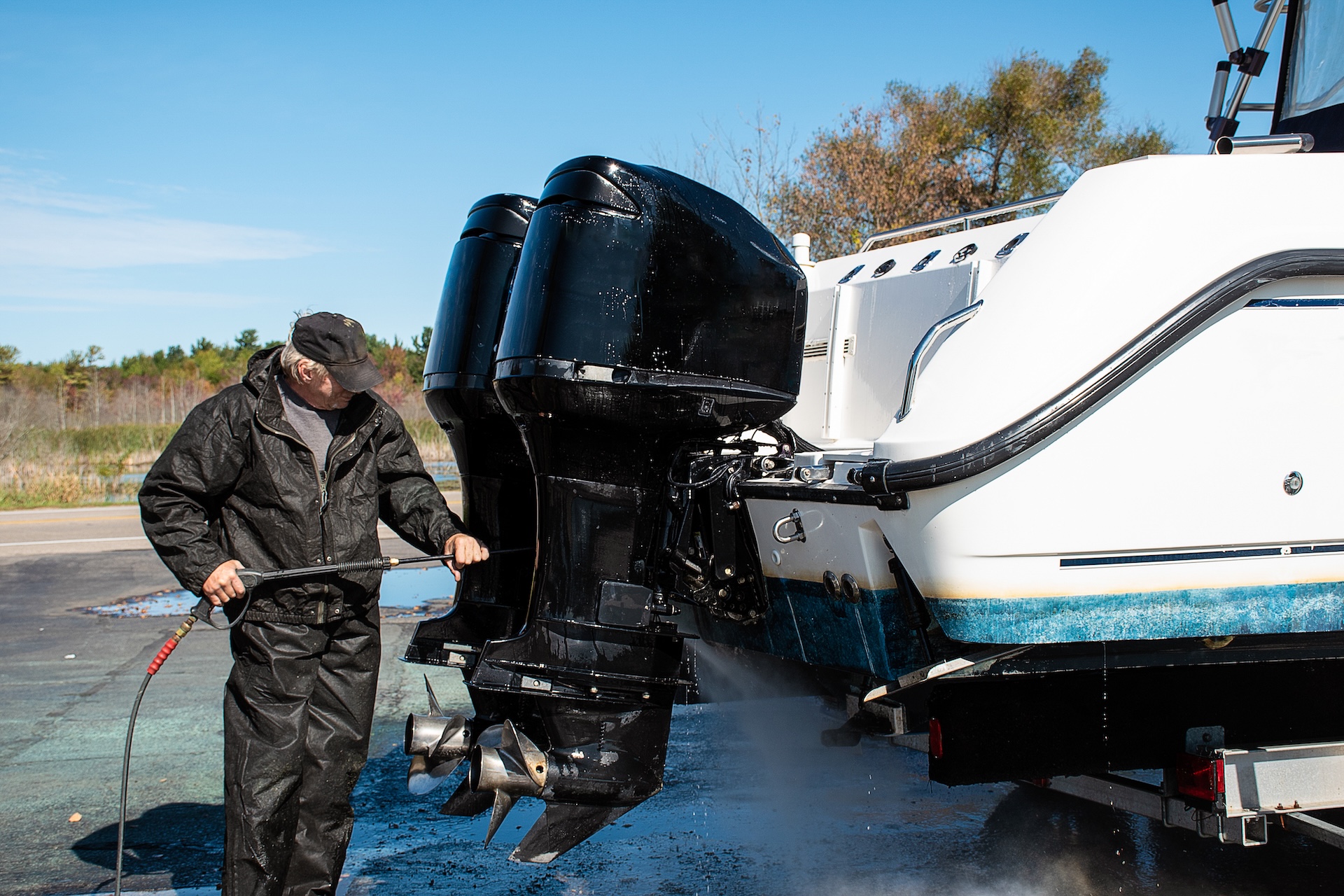 Man works on boat engines, spring boat checklist concept. 