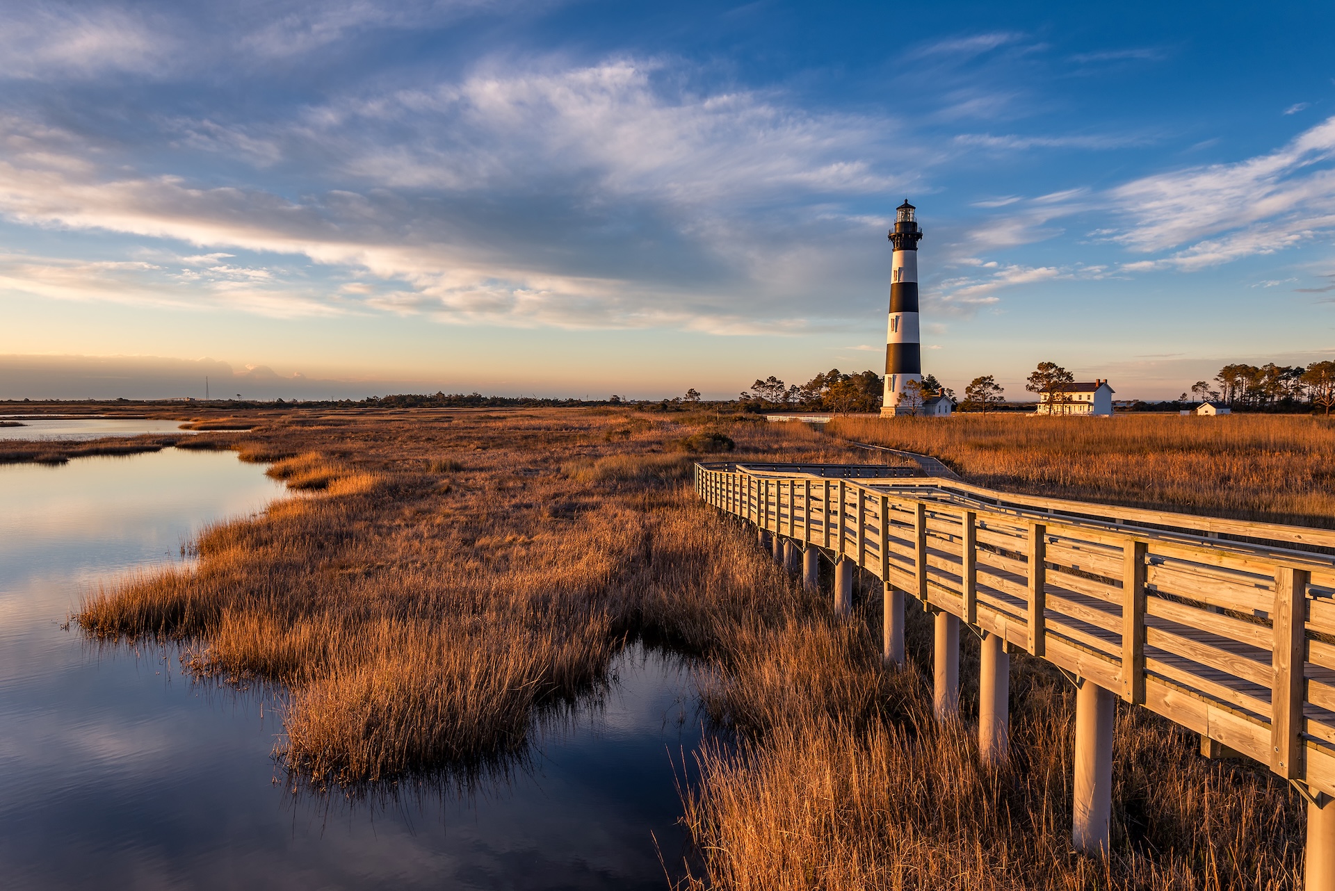 A lighthouse at the edge of the water, Outer Banks boating concept.