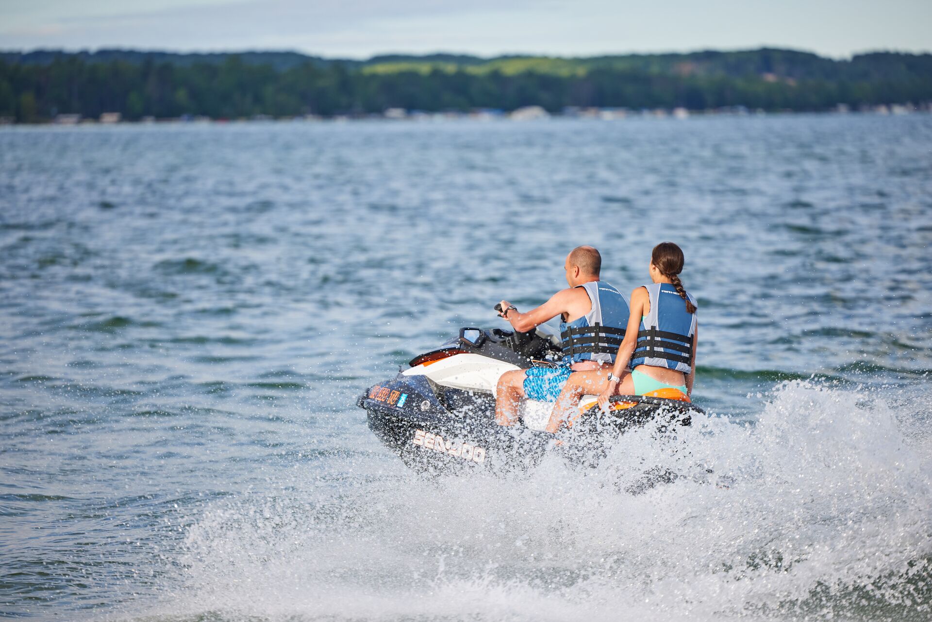 Man and girl on a jet ski on the water, boating requirements NC concept.