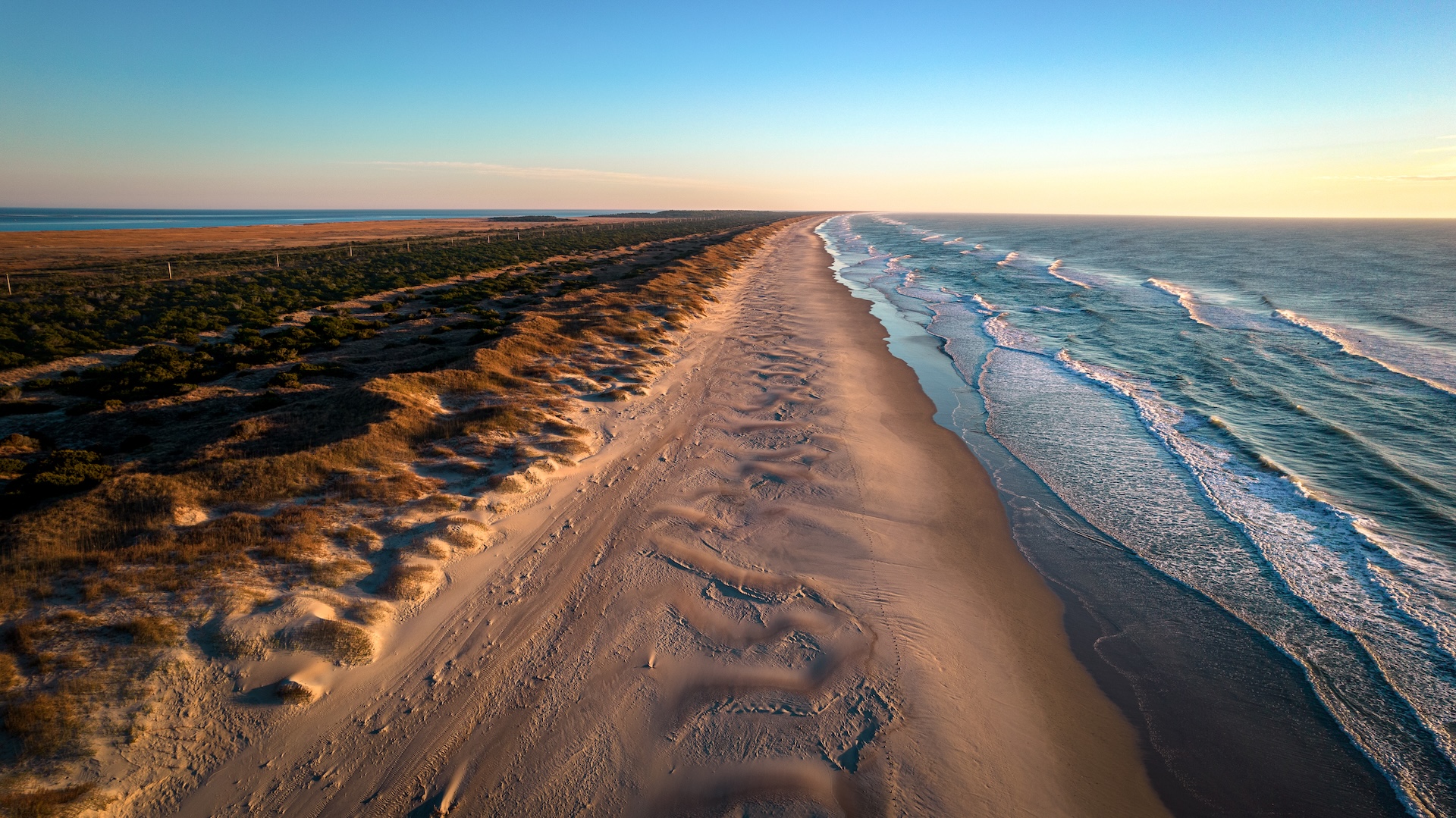 Small waves at the edge of a beach sand bar.