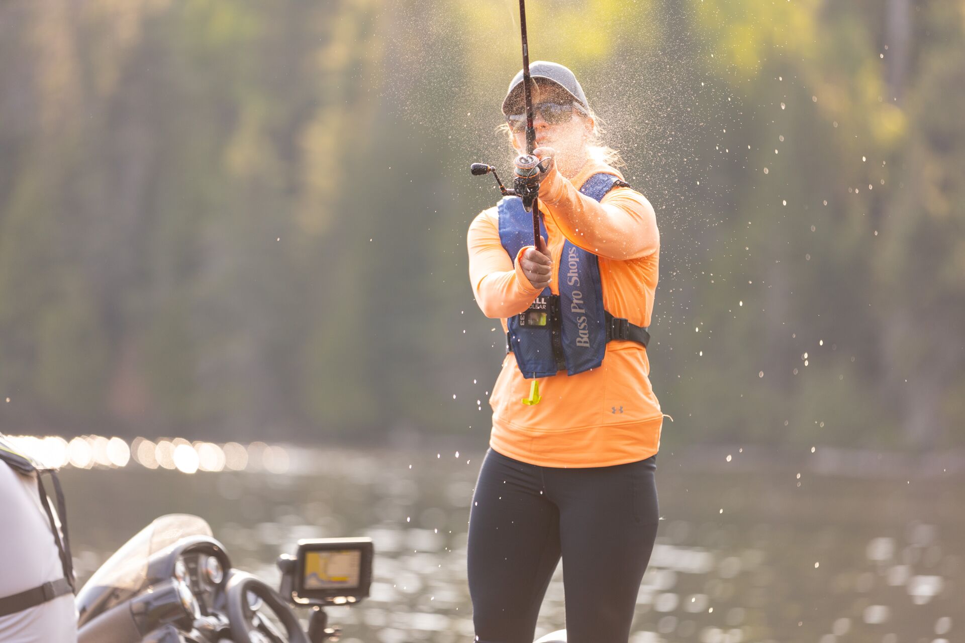 A woman wears a life jacket and casts a fishing line, Anahuac National Wildlife Refuge fishing concept.