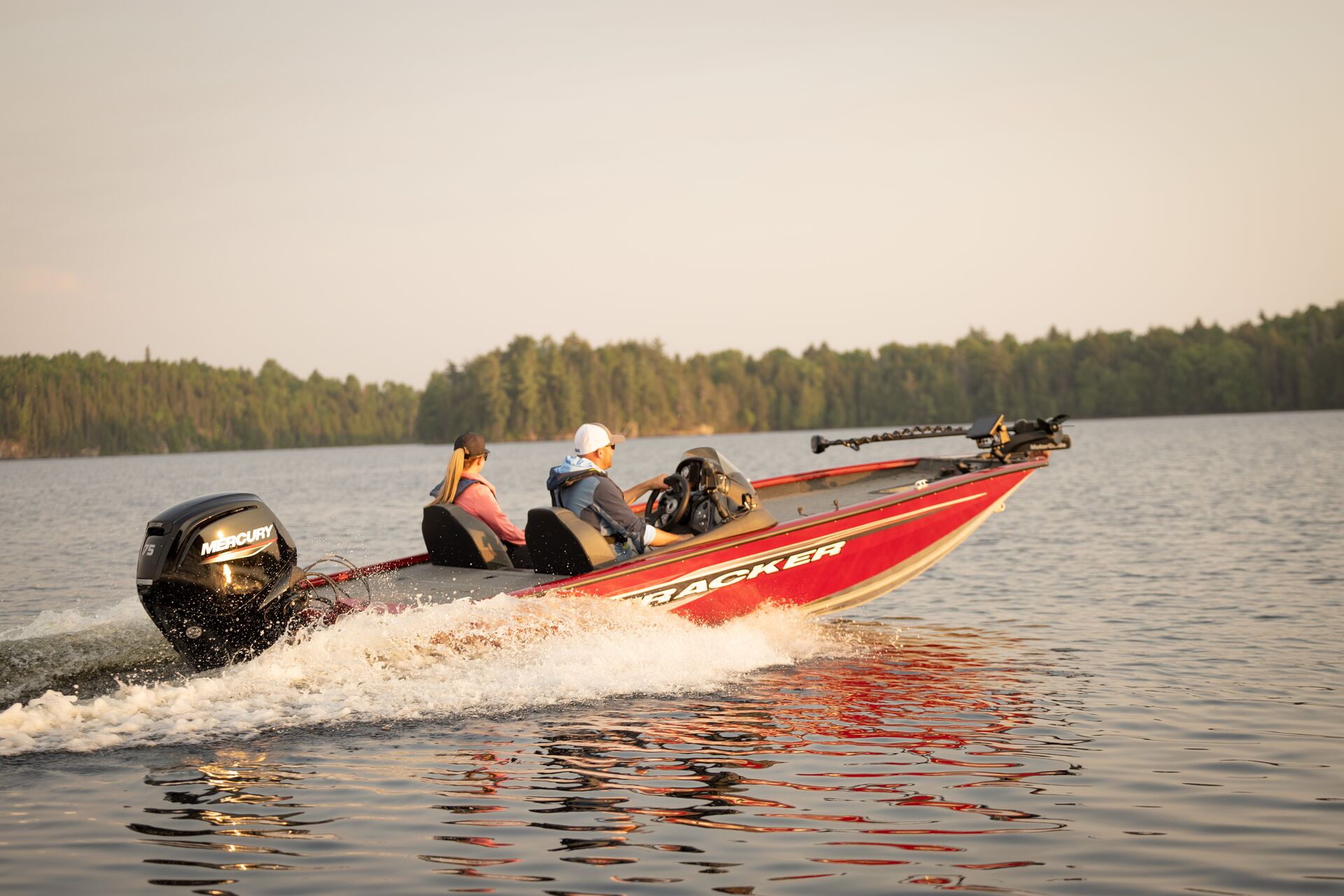 Man and woman driving red fishing boat, National Fishing and Boating Week concept.
