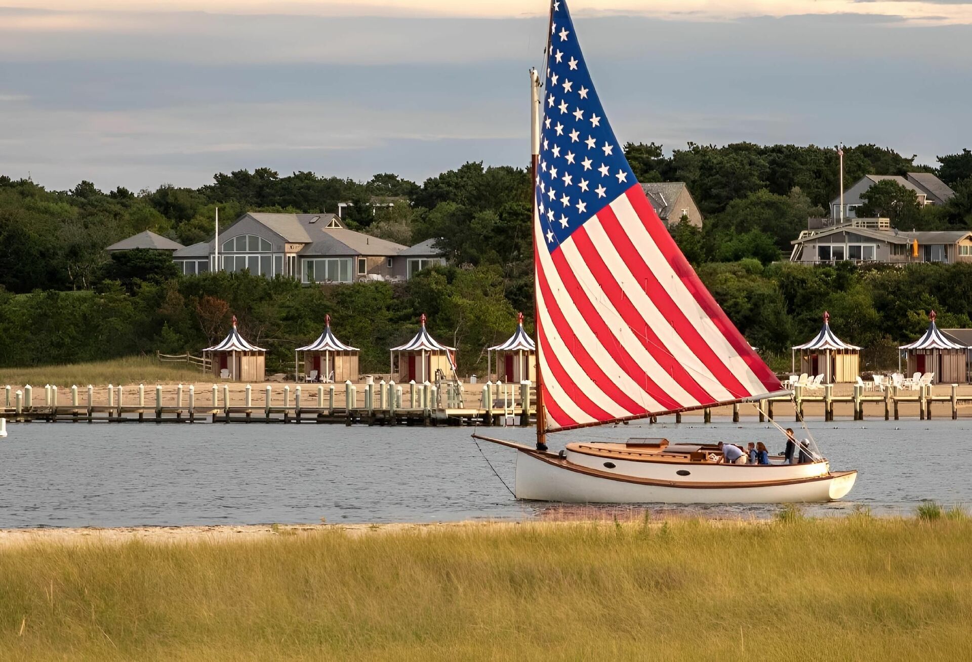 Sailboat with a U.S. flag sail, sailing during Summer Sailstice concept. 