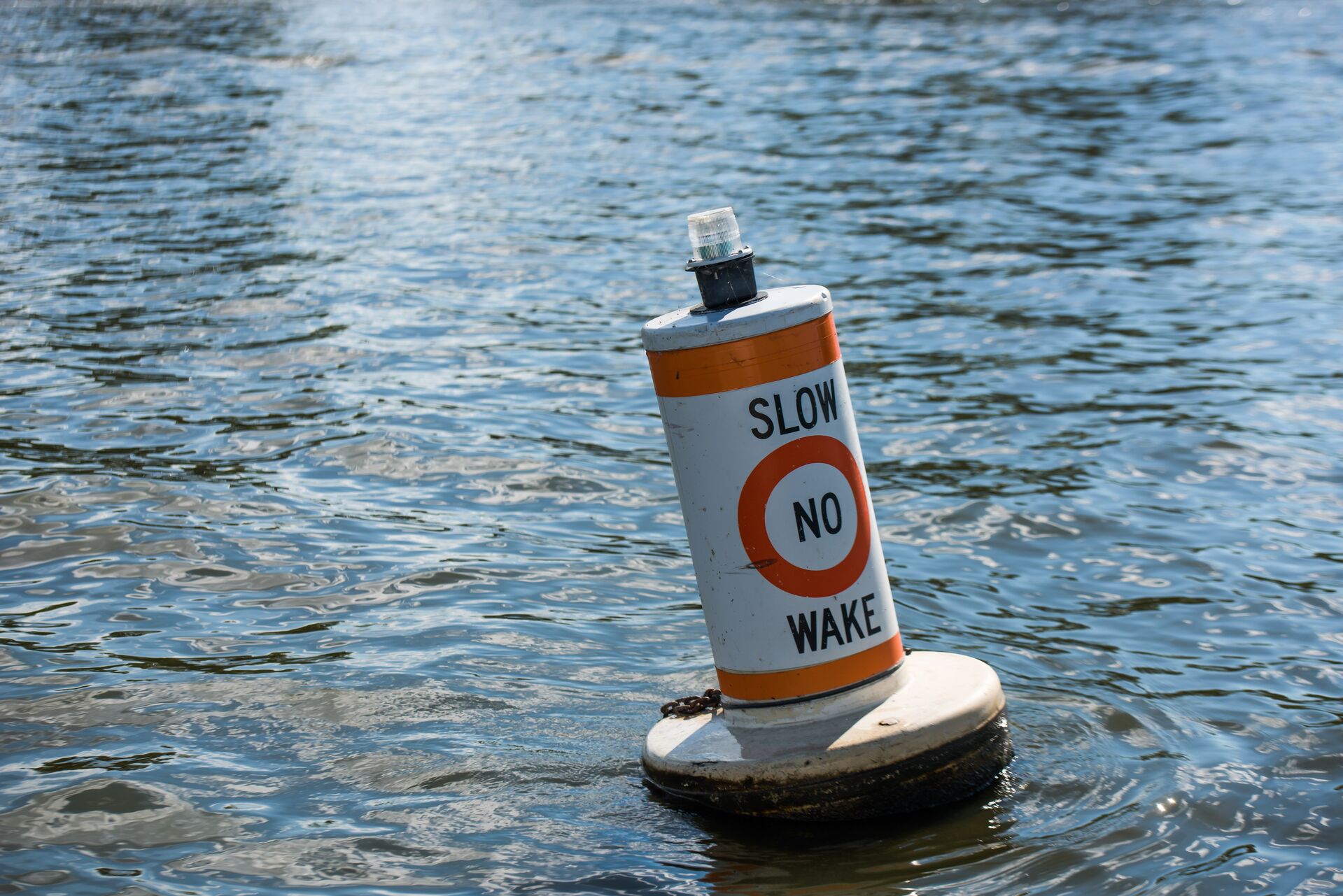 Slow no wake buoy on the water, boat signs on the water concept. 