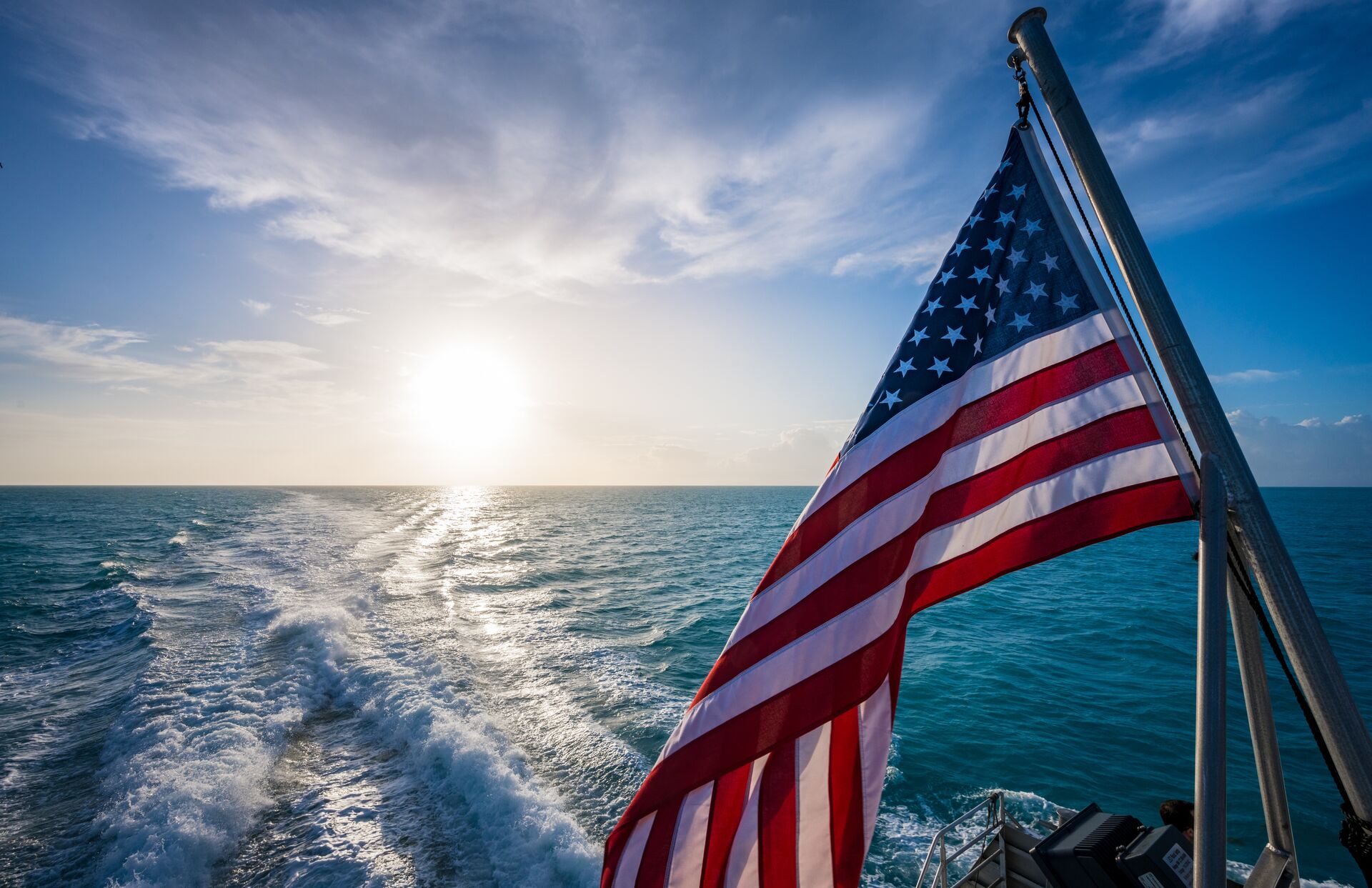 A U.S. flag on a boat on the water, 4th of July boat ride safety concept. 