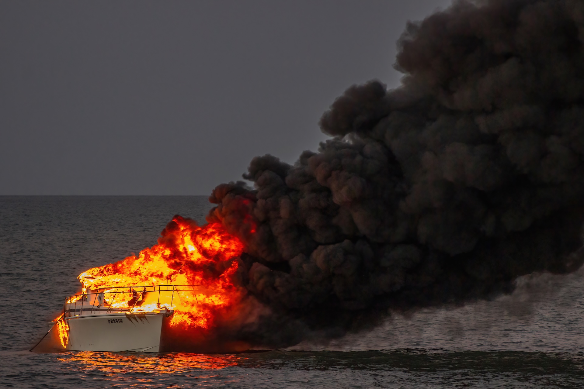 Boat on fire on the water. 