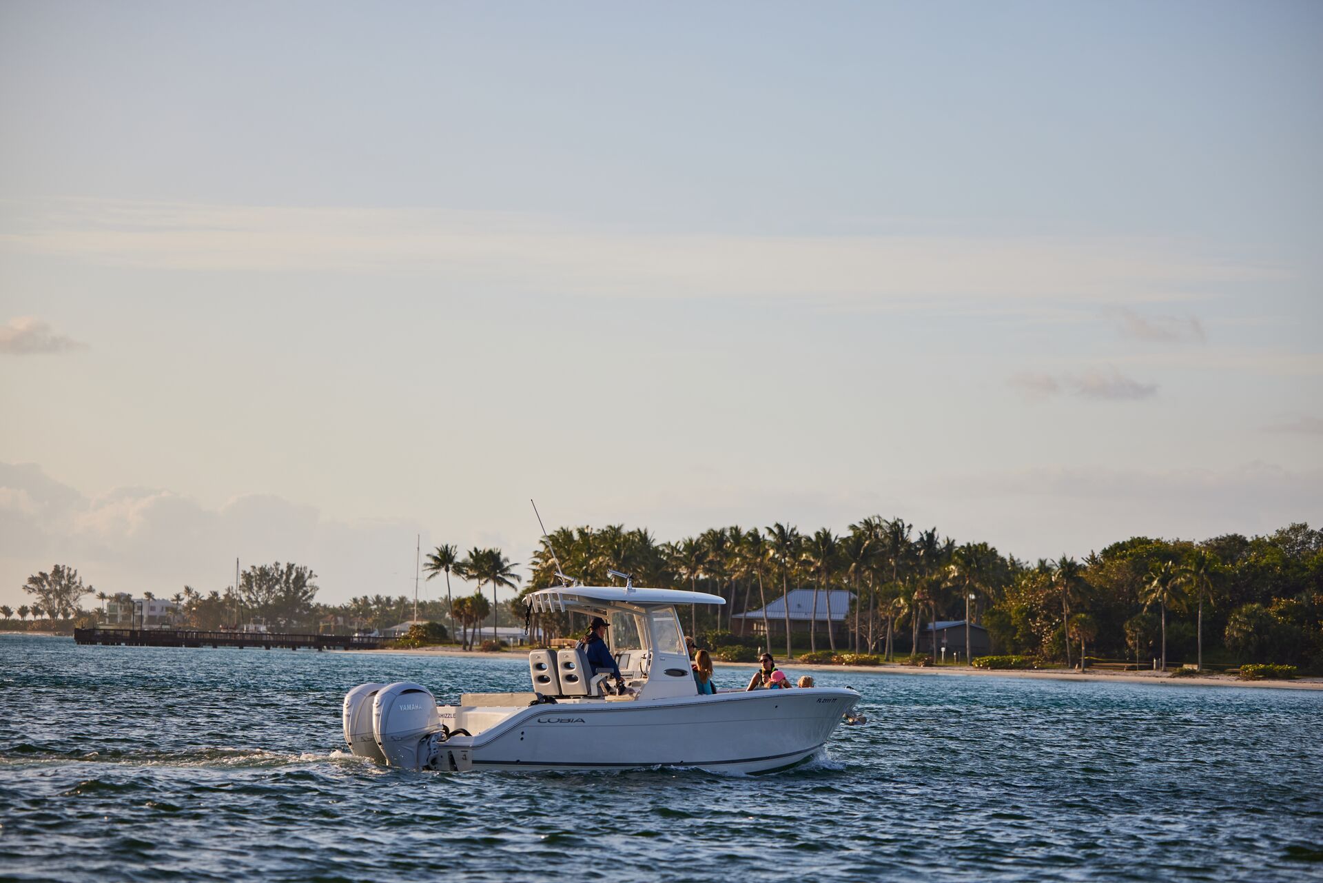 Boat full of people cruising near shore, Labor Day boating concept. 