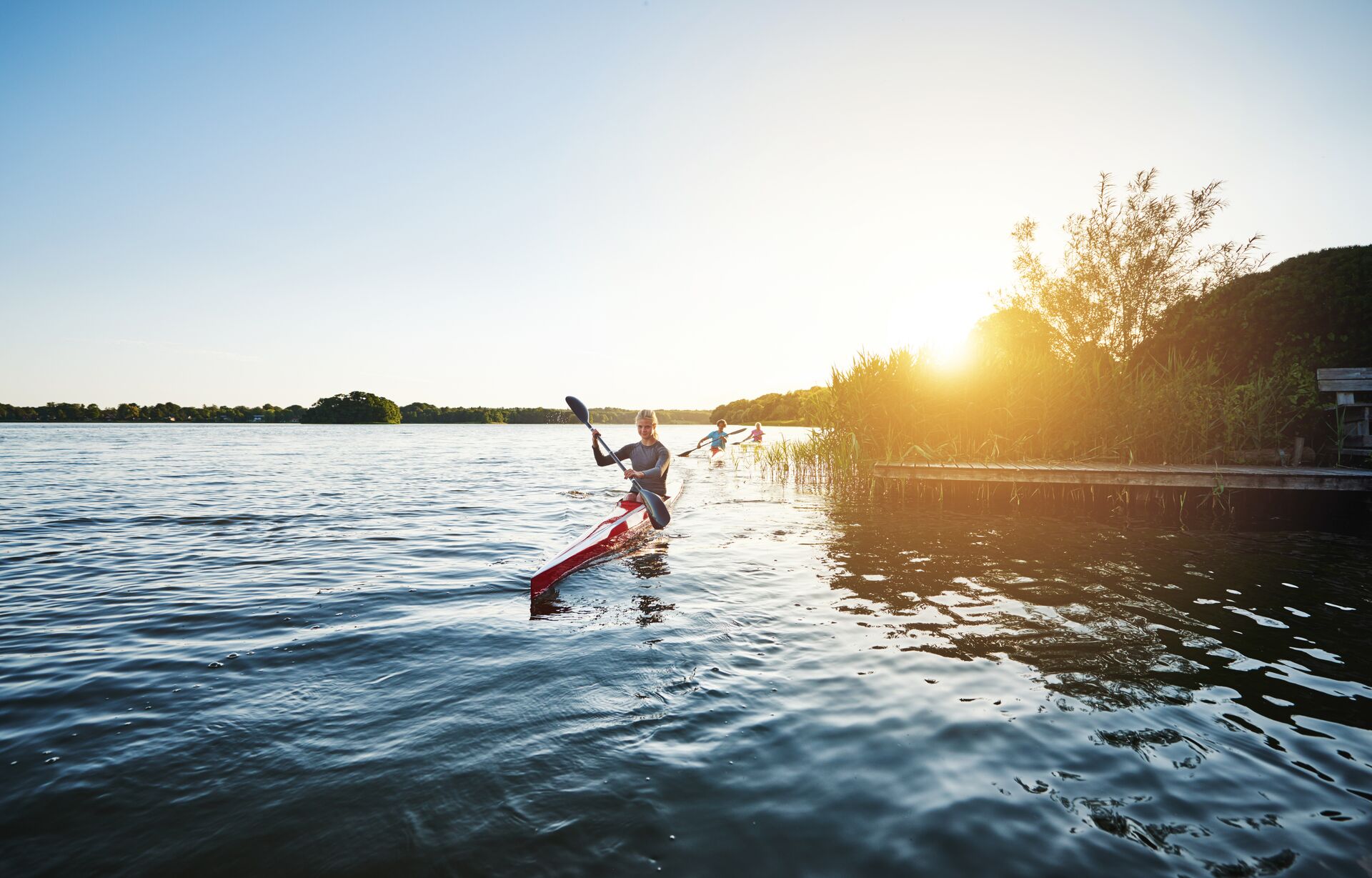 Kayakers coming around a corner near short, best life vest for kayaking concept. 