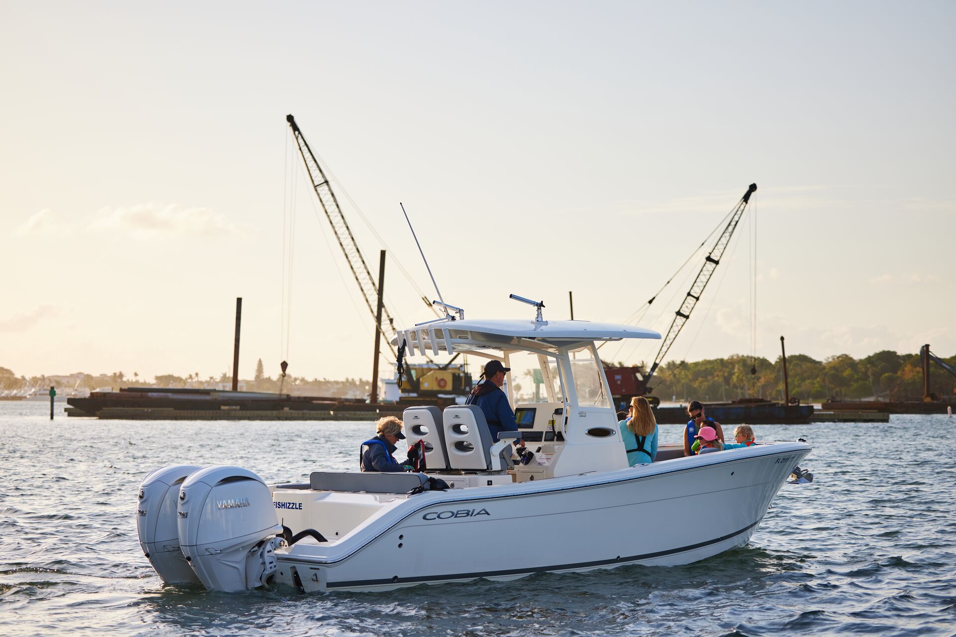 A white boat moves on the water.