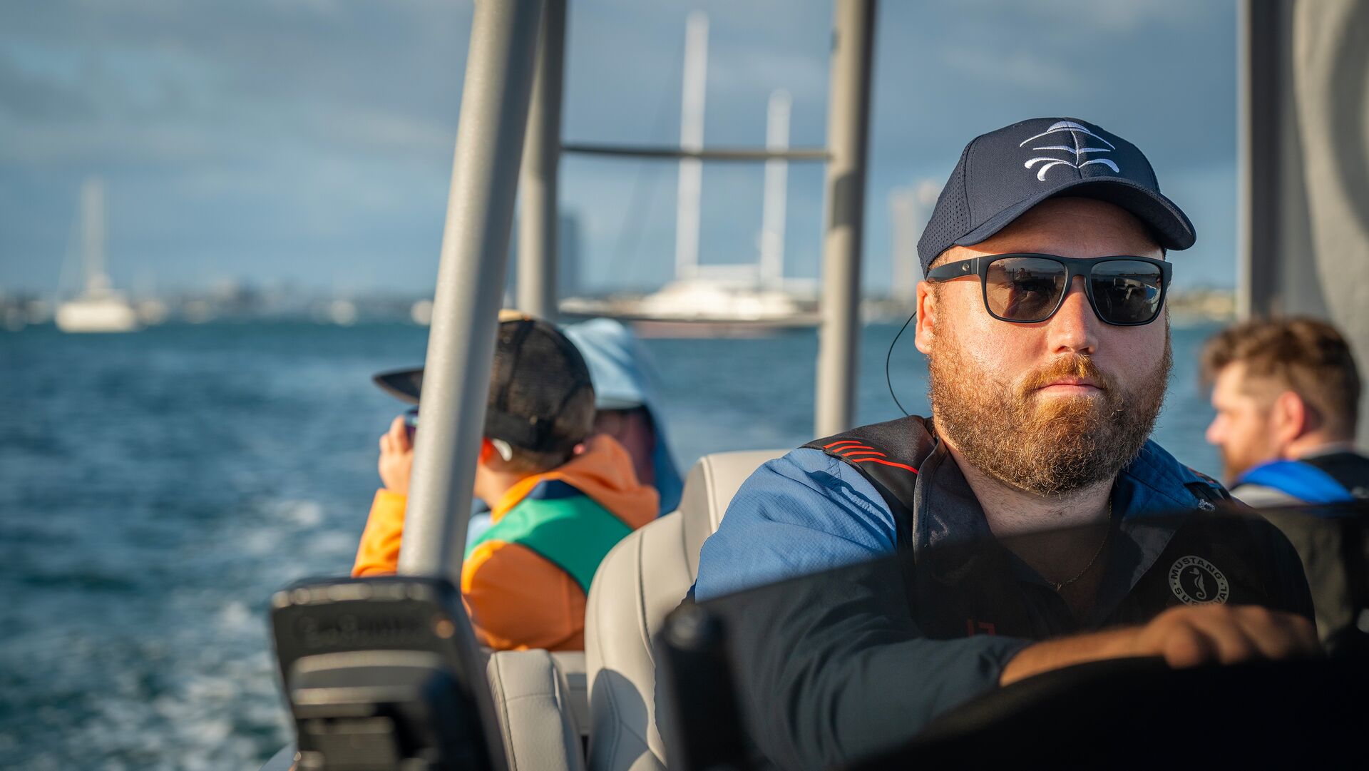 A man drives a boat with people on it, understand the parts of a boat before launching concept.