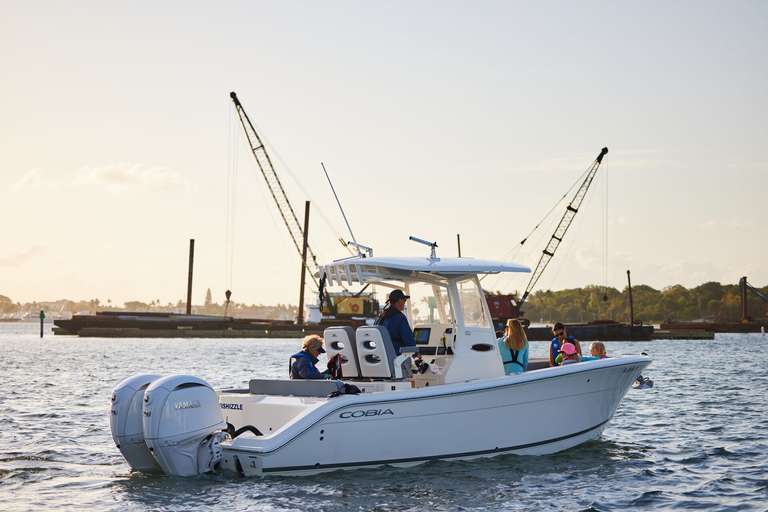 A white boat moves on the water.