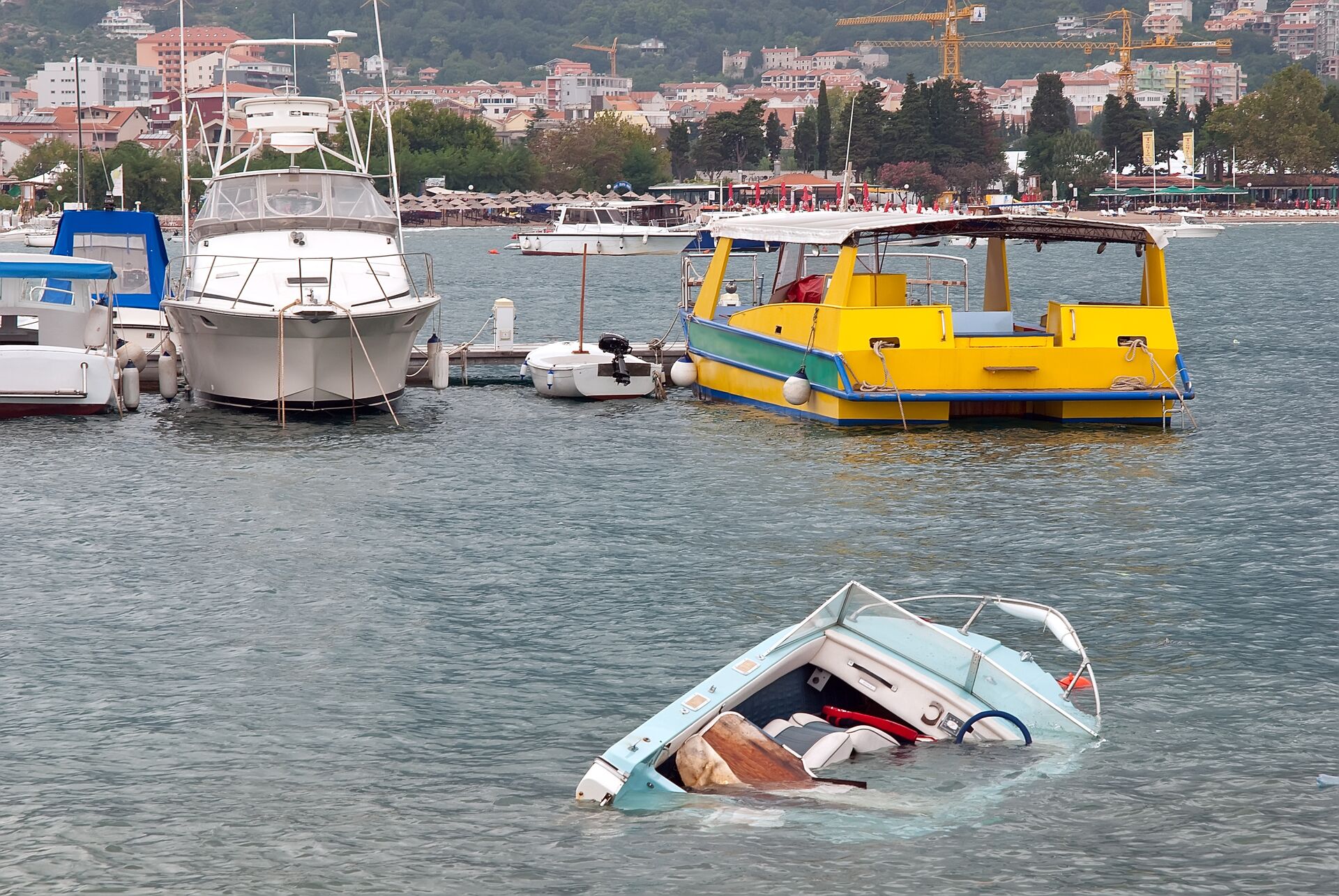 Boat sinking in the water, avoid common boating accident injuries concept. 