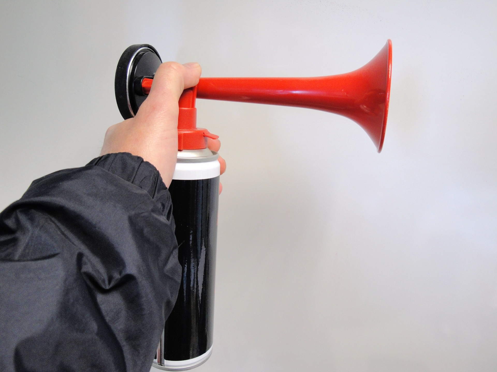 Hand holding horn for boat sound signals. 