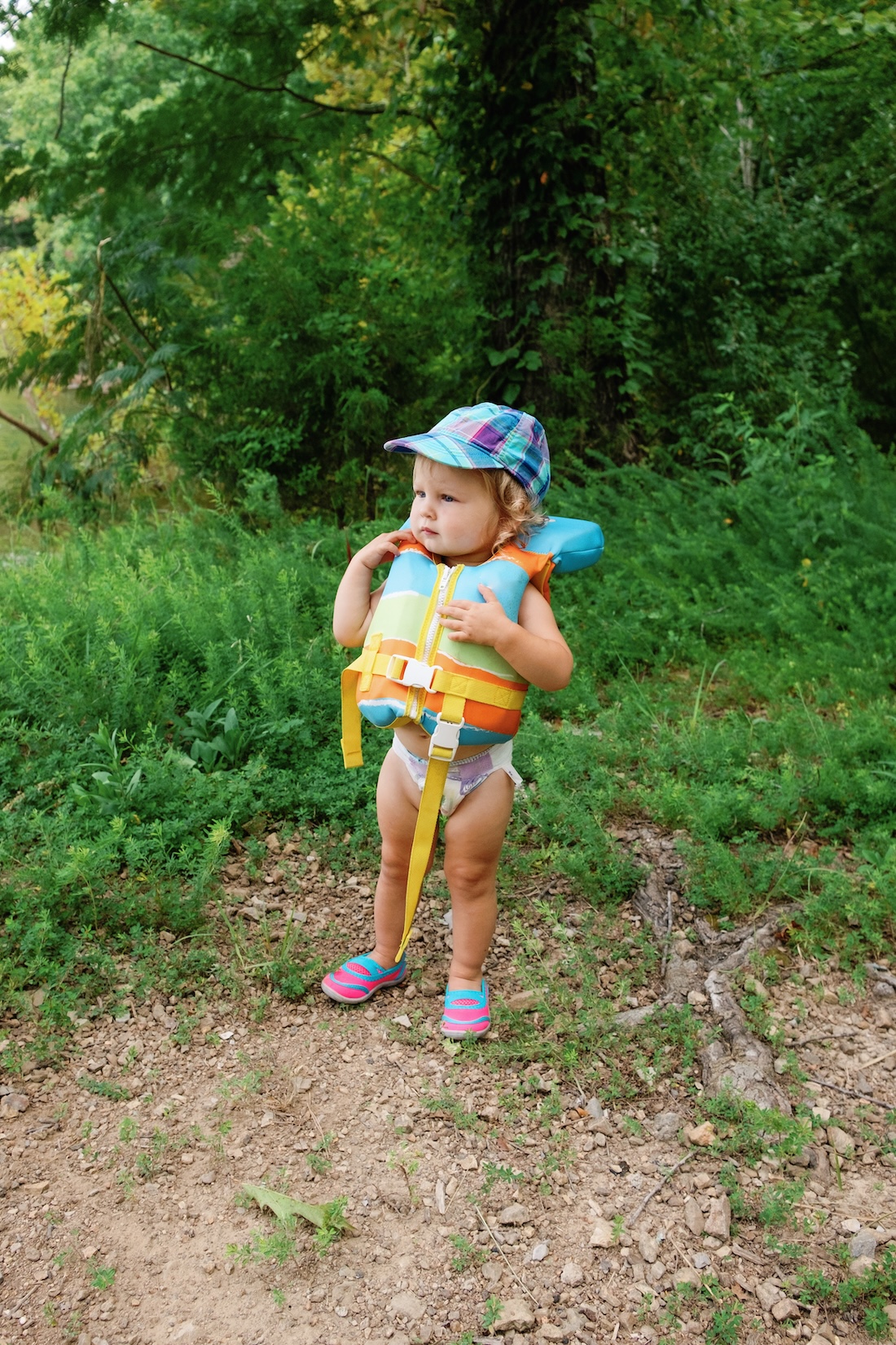 Toddler in a life jacket, infant PFD requirements concept. 